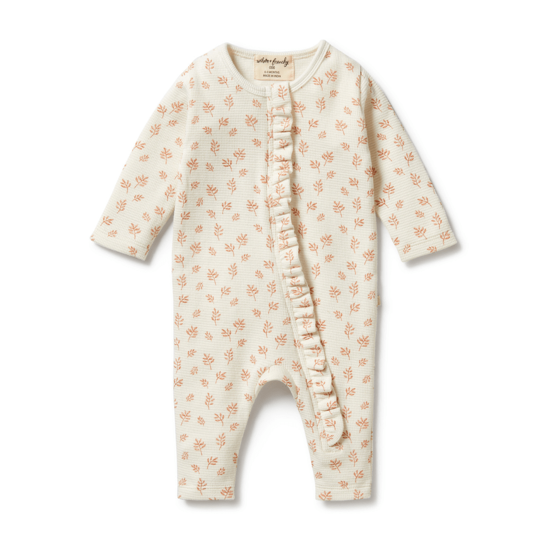 Wilson & Frenchy Organic Waffle Ruffle Zipsuit with coral pattern on a white background, made from GOTS-certified organic cotton.