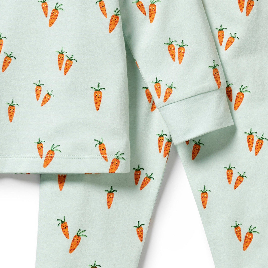 Fabric with a carrot print pattern on Wilson & Frenchy Organic Long Sleeve Easter Pyjamas.