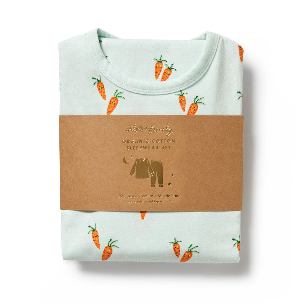 Folded Wilson & Frenchy Organic Long Sleeve Easter pyjamas set with carrot pattern wrapped in a brown paper band labeled 'organic cotton sleepy set'.