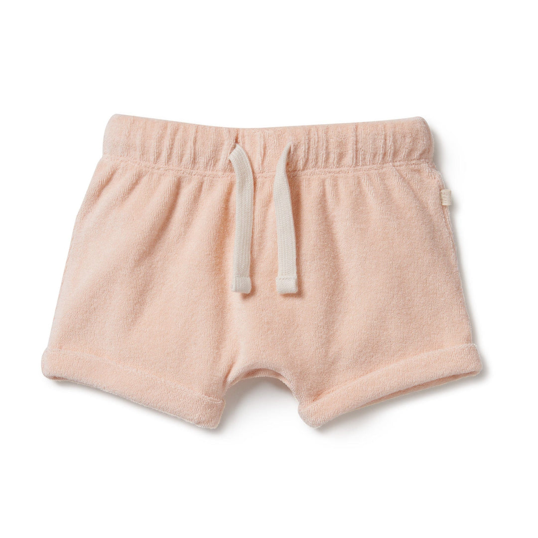 A baby's Wilson & Frenchy Organic Terry Cuffed Shorts in pink with an elastic waistband made from organic cotton for extra comfort.