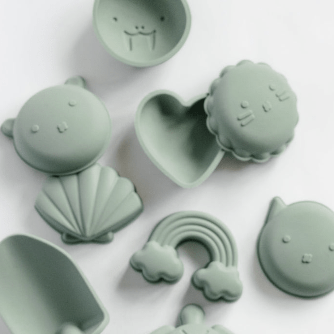 A set of Classical Child green plastic beach moulds.
