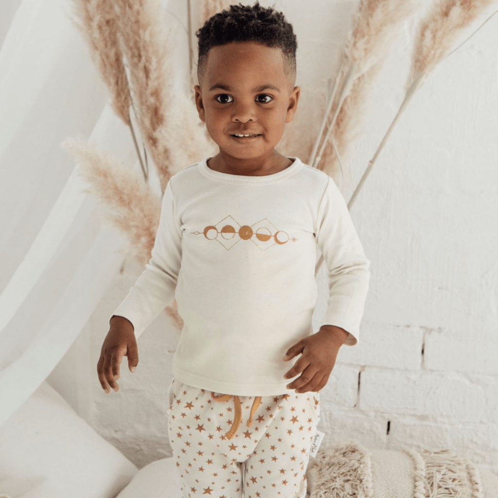 Adorable-Boy-Smiling-Wearing-Aster-and-Oak-Long-Sleeve-Tee-Moon-Phases-Naked-Baby-Eco-Boutique