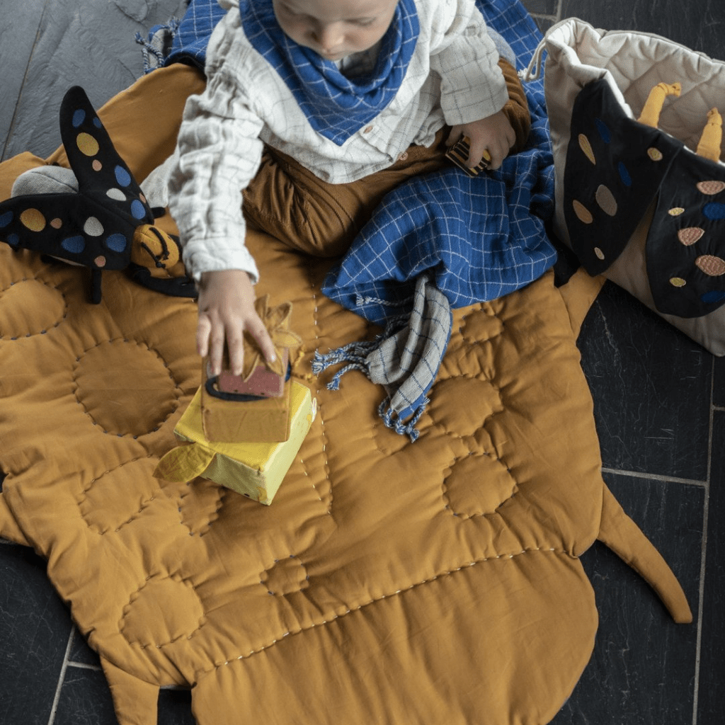 Aerial-View-of-Child-Playing-on-Fabelab-Organic-Cotton-Quilted-Baby-Blanket-Beetle-Naked-Baby-Eco-Boutique