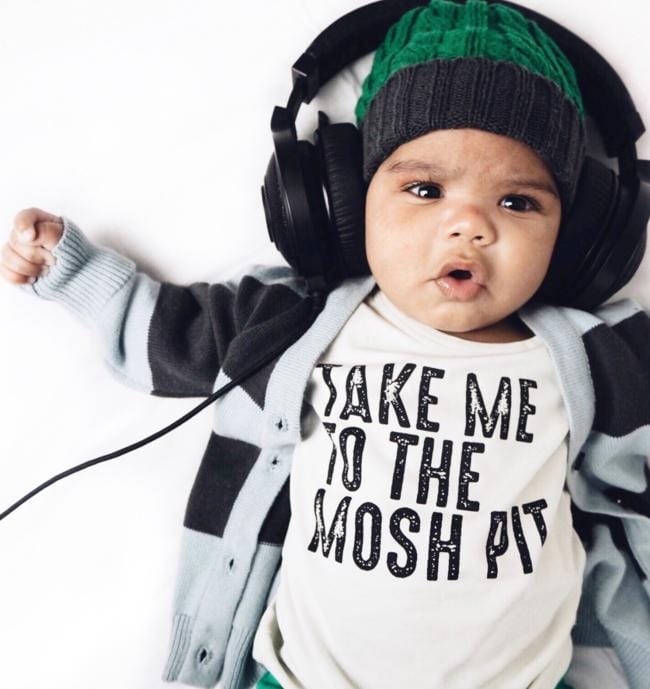 A baby wearing an Anarkid Organic Cotton Knitted Beanie (Emerald) - LUCKY LAST - 3-6 MONTHS ONLY and Anarkid organic cotton headphones.