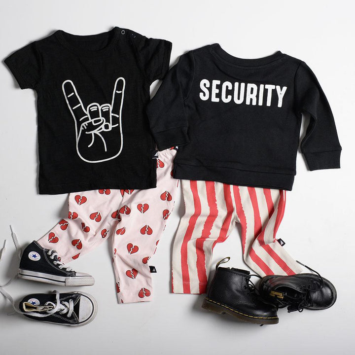 An Anarkid black t-shirt and a pair of Anarkid jeans featuring the word security.