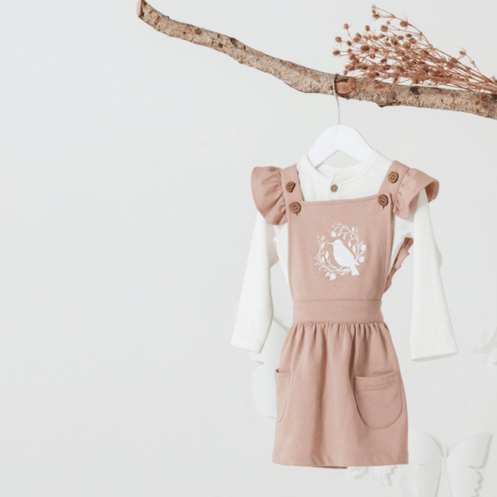 Aster-And-Oak-Organic-Song-Bird-Embroidered-Pinafore-Dress-Hanging-On-Branch-Naked-Baby-Eco-Boutique