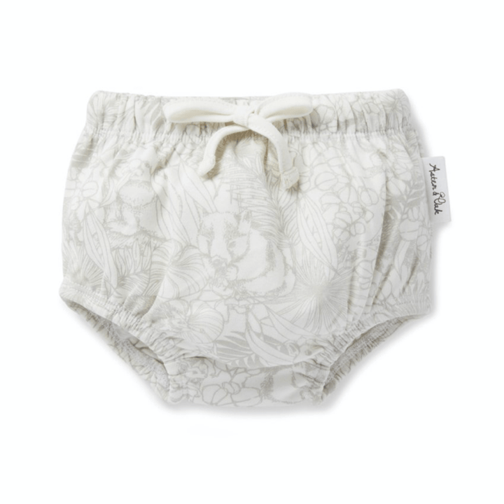 An Aster & Oak white baby diaper with a floral pattern.