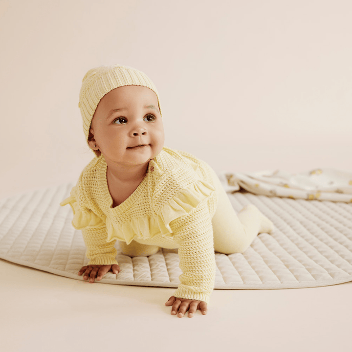 Baby-Crawling-Wearing-Wilson-and-Frenchy-Knitted-Legging-with-Feet-Pastel-Yellow-Naked-Baby-Eco-Boutique