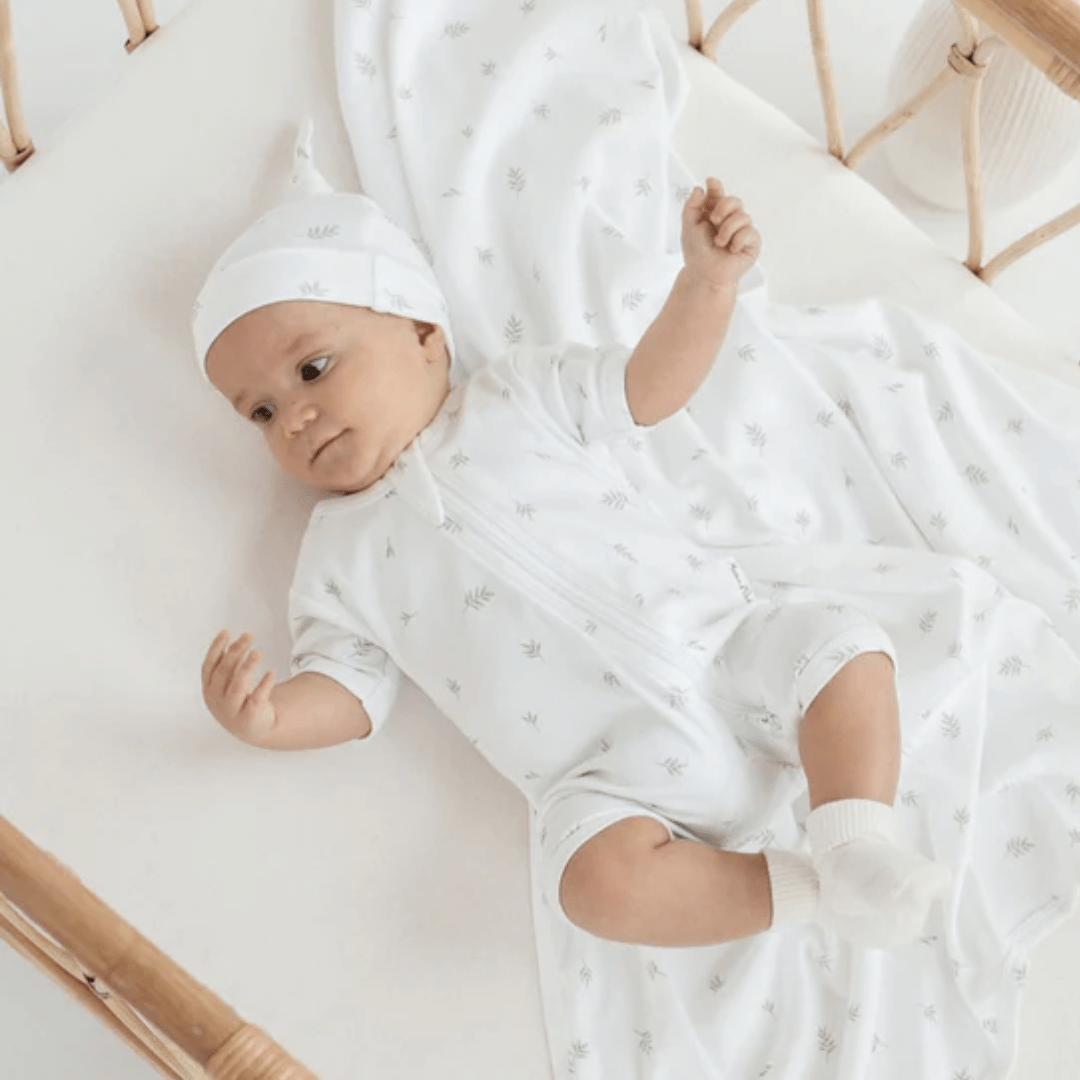 Baby-In-Cot-Wearing-Aster-And-Oak-Organic-Cotton-Zip-Romper-Little-Leaf-Naked-Baby-Eco-Boutique