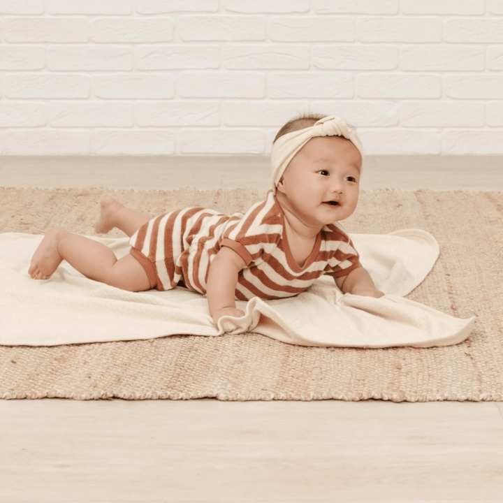 Baby-Lying-on-Tummy-Wearing-Quincy-Mae-Organic-Terry-Retro-Romper-Amber-Stripe-Naked-Baby-Eco-Boutique
