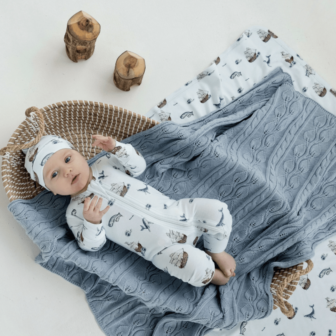 Baby-Lying-with-Aster-and-Oak-Organic-Cotton-Baby-Swaddle-Wrap-Whale-Naked-Baby-Eco-Boutique