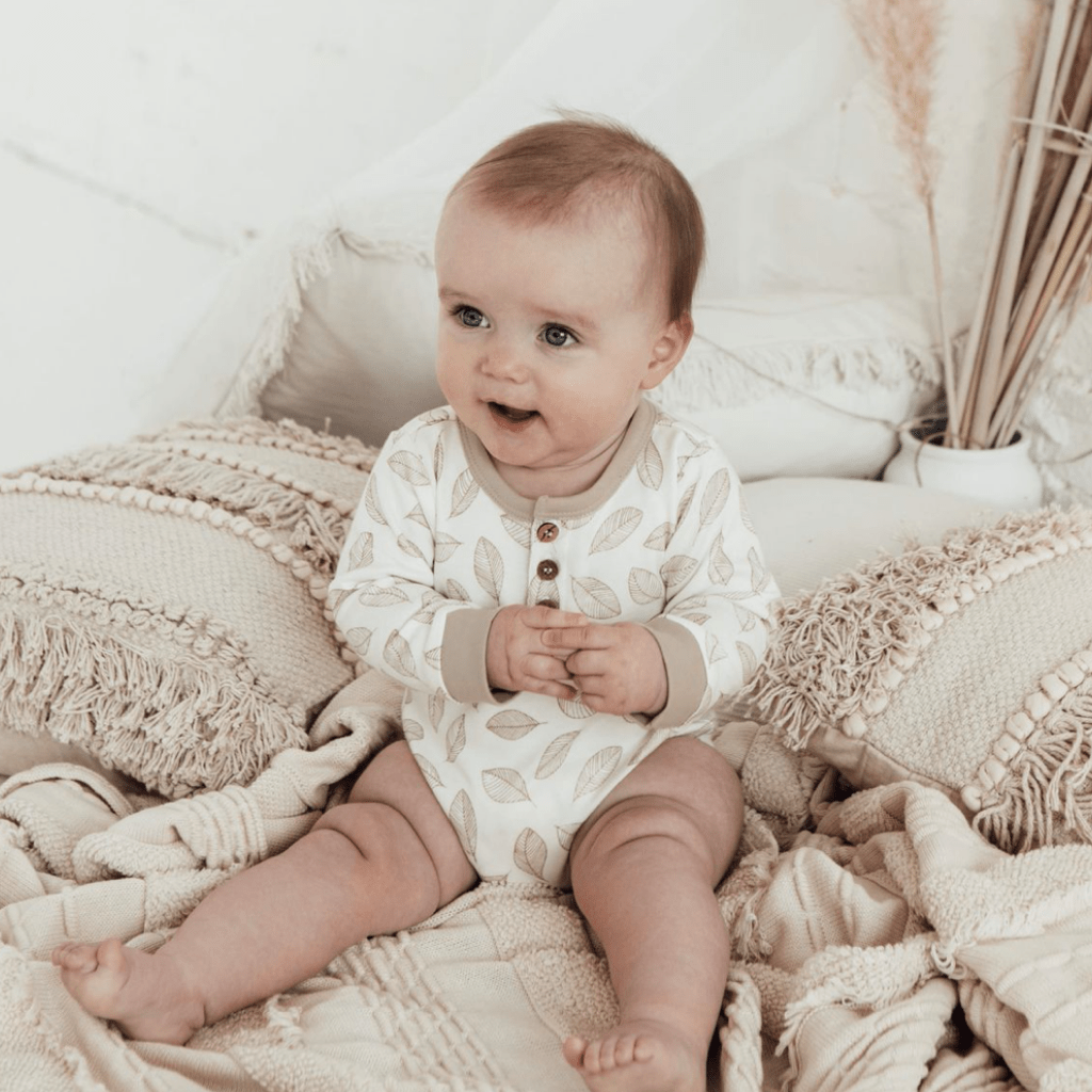 Baby-Sitting-Wearing-Aster-and-Oak-Organic-Cotton-AOP-Henley-Onesie-Leaf-Drop-Naked-Baby-Eco-Boutique