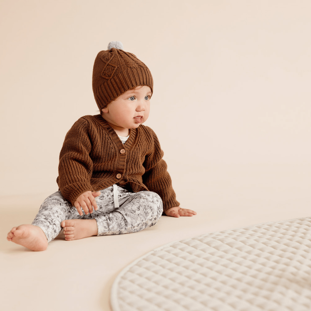 Baby-Sitting-Wearing-Beanie-and-Wilson-and-Frenchy-Organic-Cotton-Leggings-Forest-Animals-Naked-Baby-Eco-Boutique