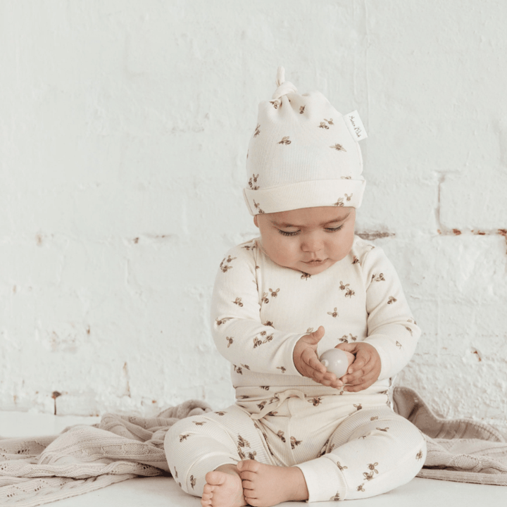 Baby-Sitting-holding-Toy-Wearing-Aster-and-Oak-Organic-Cotton-Rib-Knotted-Beanie-Naked-Baby-Eco-Boutique