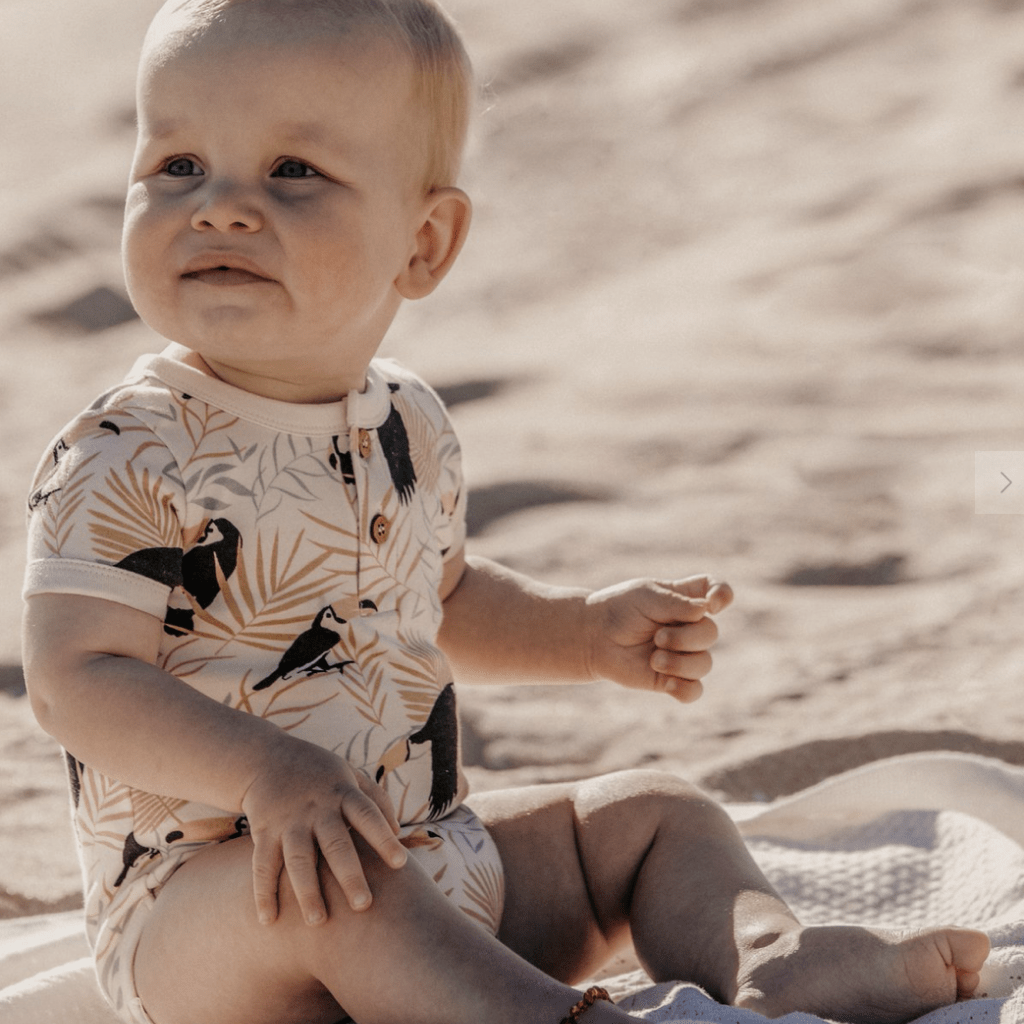 Baby-Sitting-in-Sand-Wearing-Aster-and-Oak-Organic-Toucan-Henley-Onesie-Naked-Baby-Eco-Boutique