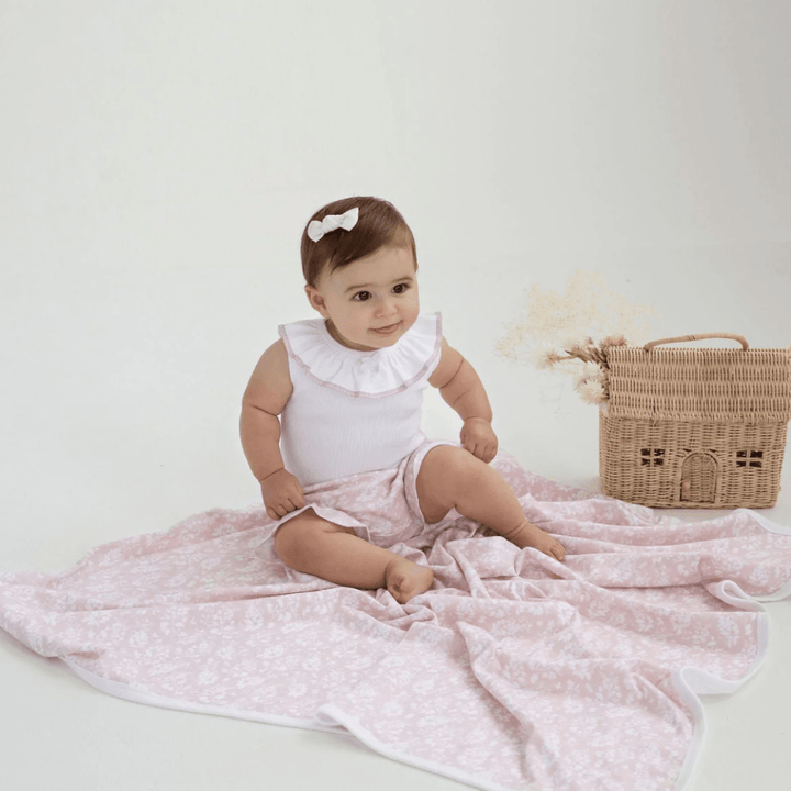 Baby-Sitting-on-Swaddle-Wearing-Aster-and-Oak-Organic-Ruffle-Bloomers-Pink-Floral-Naked-Baby-Eco-Boutique