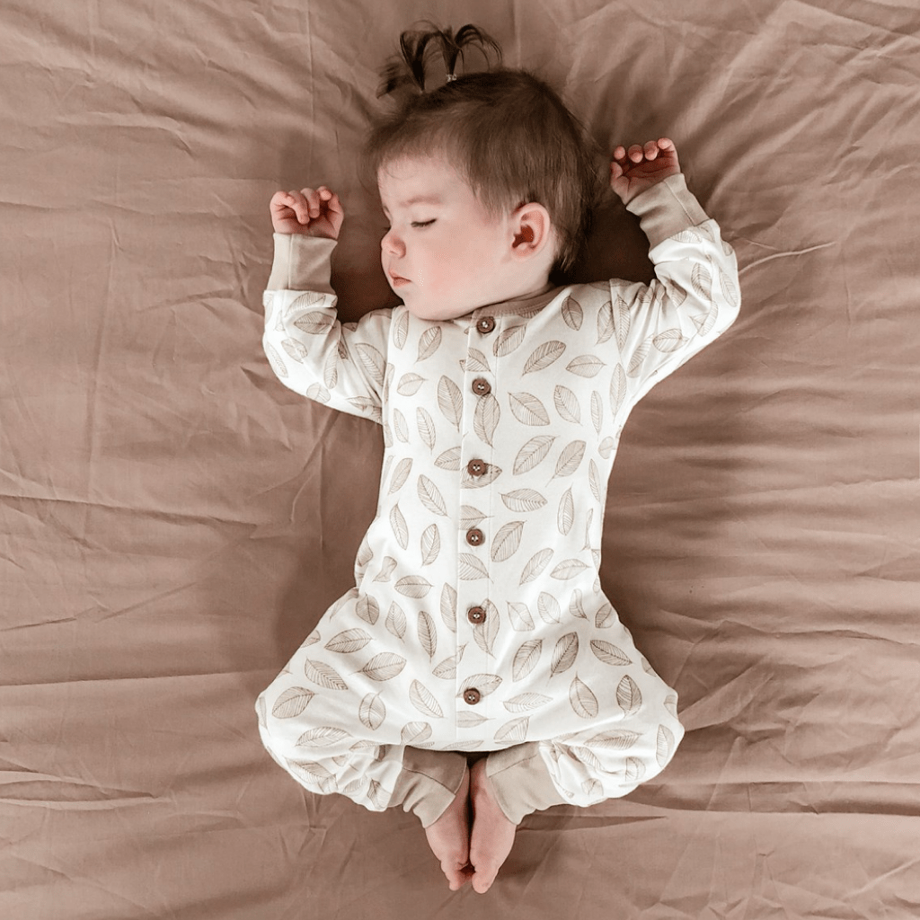 Baby-Sleeping-Wearing-Aster-and-Oak-Organic-Cotton-Button-Romper-Leaf-Drop-Naked-Baby-Eco-Boutique