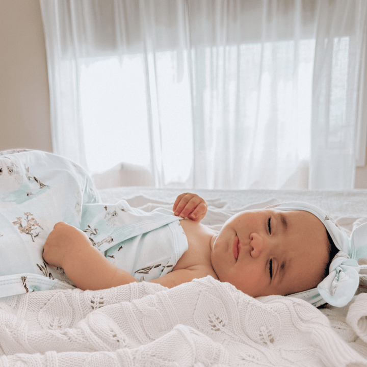 Baby-Sleeping-with-Baby-Lying-with-Aster-and-Oak-Organic-Cotton-Baby-Swaddle-Wrap-Swan-Naked-Baby-Eco-Boutique