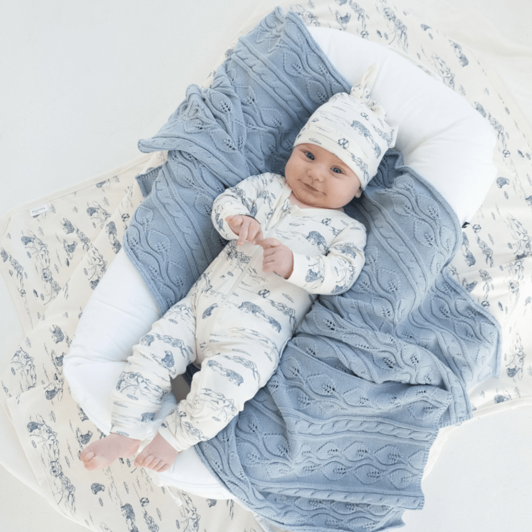 Baby-Smiling-Laying-with-Aster-and-Oak-Organic-Cotton-Baby-Swaddle-Wrap-Arctic-Naked-Baby-Eco-Boutique