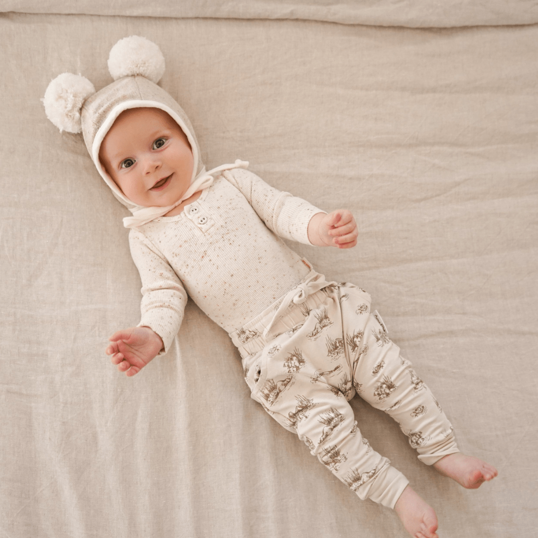 Baby-Smiling-Lying-Down-Wearing-Aster-and-Oak-Organic-Cotton-Harem-Pants-Beaver-Naked-Baby-Eco-Boutique