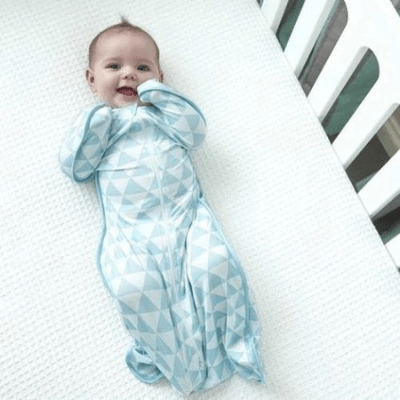 Baby-in-Cot-Wearing-Love-to-Dream-Bamboo-Swaddle-Up-Lite-Ocean-Naked-Baby-Eco-Boutique