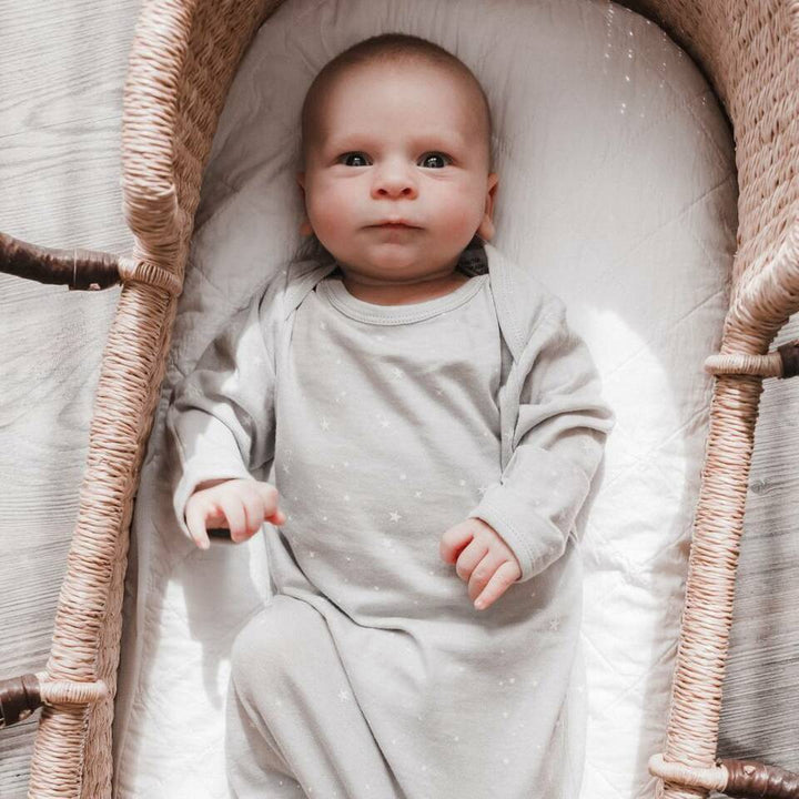 Baby-in-Moses-Basket-Wearing-Woolbabe-Merino-and-Organic-Cotton-Sleeping-Gown-Pebble-Stars-Naked-Baby-Eco-Boutique