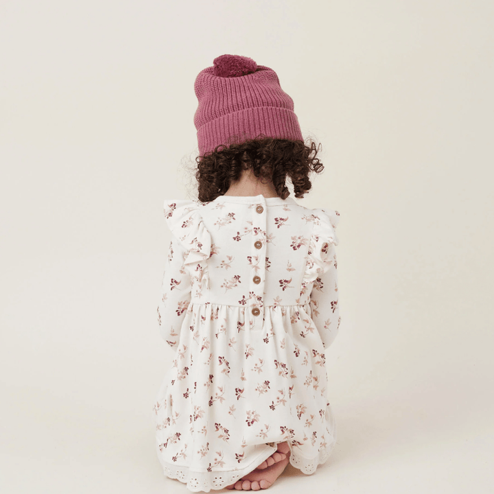 Back-View-of-Little-Girl-Kneeling-Wearing-Aster-and-Oak-Organic-Ruffle-Dress-Berry-Naked-Baby-Eco-Boutique
