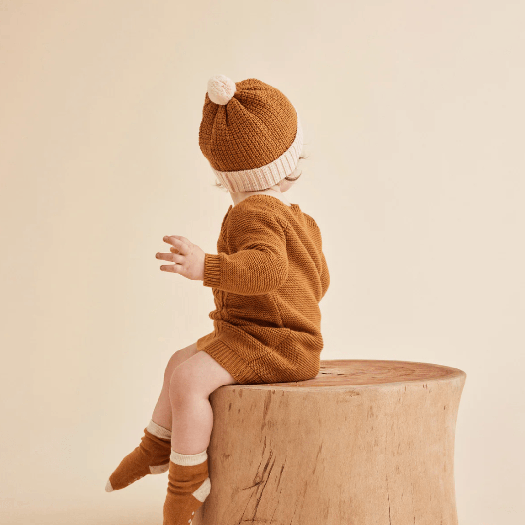 Back-View-of-Toddler-Sitting-Wearing-Wilson-and-Frenchy-Knitted-Splice-Hat-Naked-Baby-Eco-Boutique