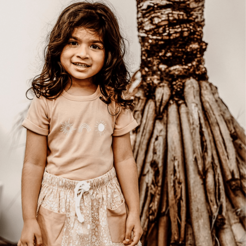 Beautiful-Little-Girl-Wearing-Aster-and-Oak-Organic-Rainbow-Sun-Tee-Naked-Baby-Eco-Boutique