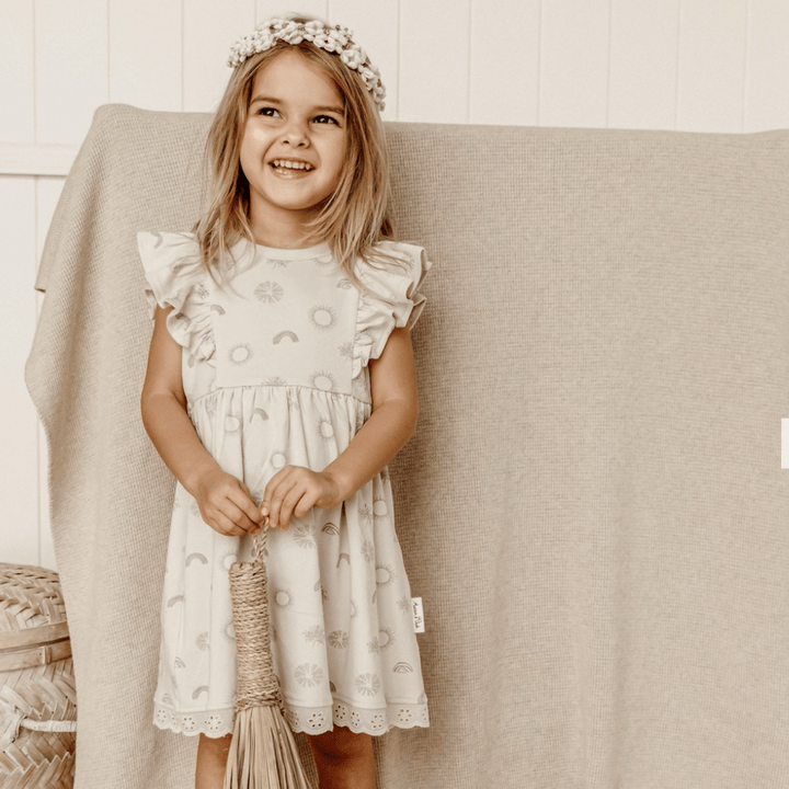 Beautiful-Little-Girl-Wearing-Aster-and-Oak-Sunny-Daze-Ruffle-Dress-Naked-Baby-Eco-Boutique
