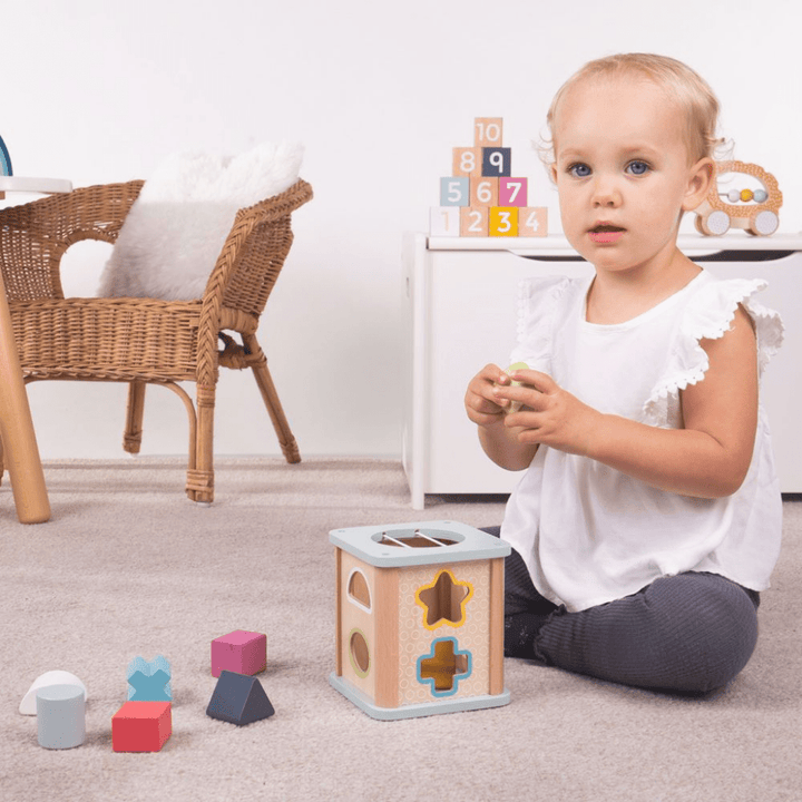Bigjigs-Shape-Sorter-Little-Girl-Playing-With-Shapes-Naked-Baby-Eco-Boutique