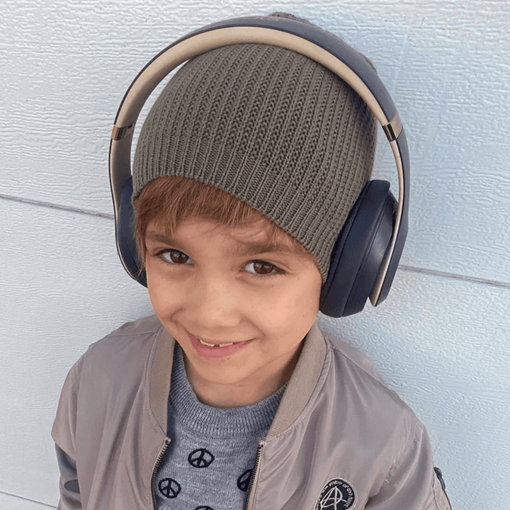 A young boy wearing the Anarkid Organic Cotton Knitted Beanie (Multiple Variants) by Anarkid.