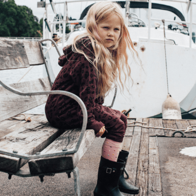 Child-Sitting-on-Bench-by-Boat-Wearing-New-2022-Lamington-Merino-Wool-Knee-High-Socks-Hundreds-and-Thousands-Naked-Baby-Eco-Boutique