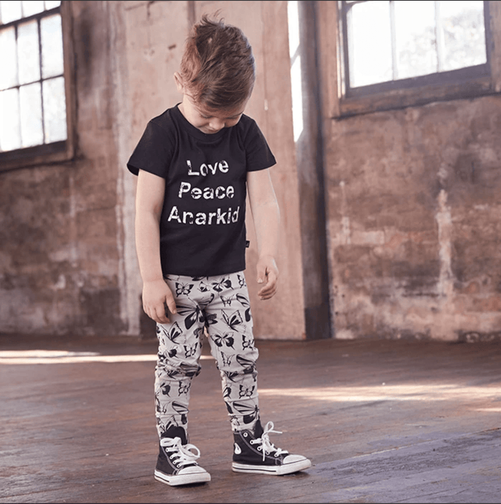 A little boy wearing an Anarkid Organic Cotton Acid Wash T-Shirt.