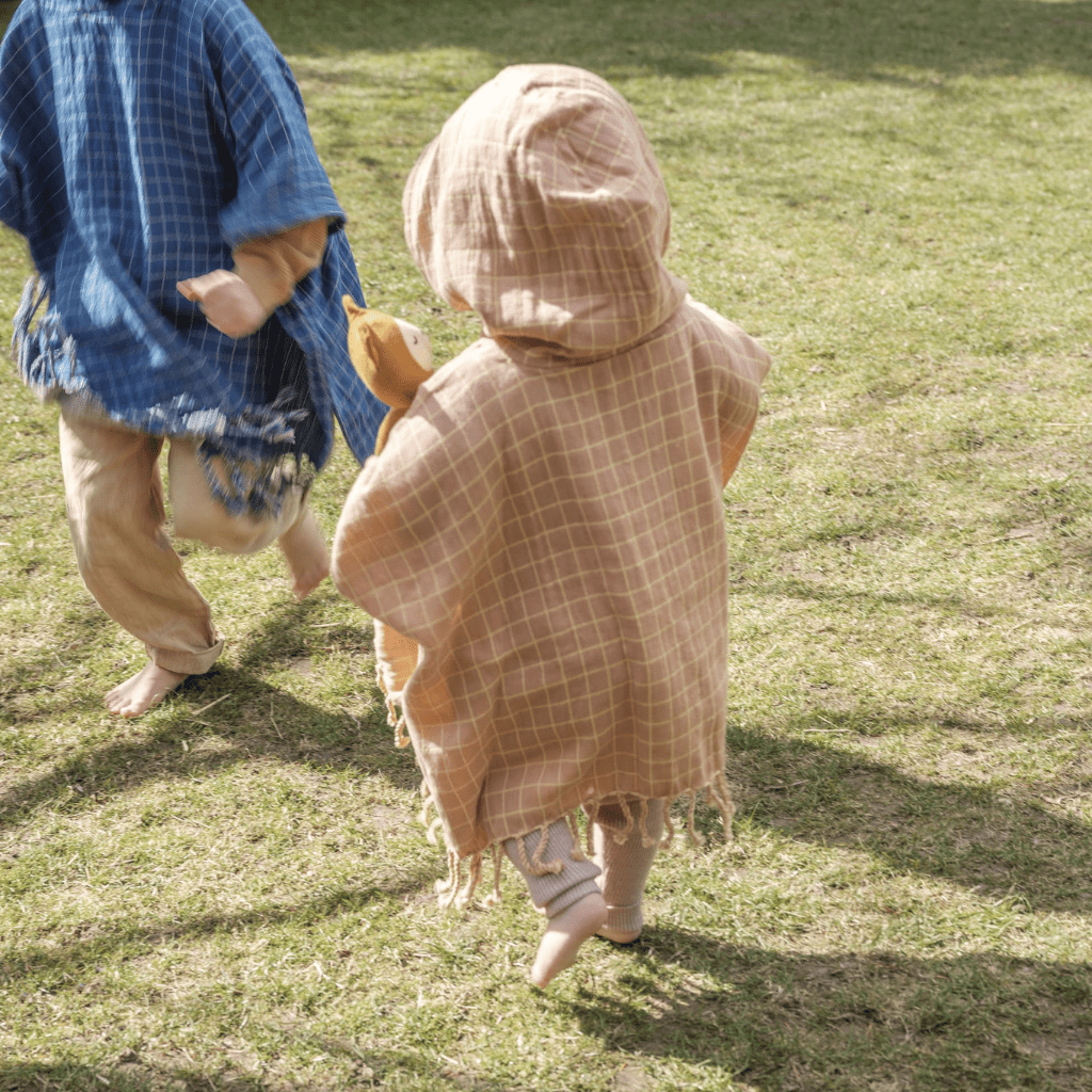 Children-Running-Outside-Wearing-Fabelab-Organic-Cotton-Grid-Kids-Poncho-Naked-Baby-Eco-Boutique