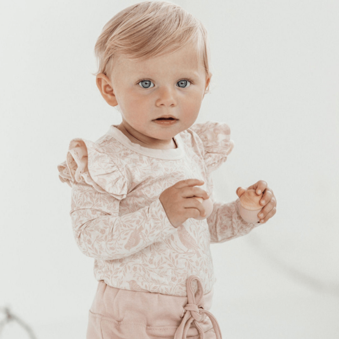 Close-Up-Of-Aster-And-Oak-Song-Bird-Ruffle-Onesie-Naked-Baby-Eco-Boutique
