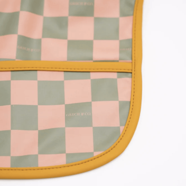 Close-Up-Of-Grech-And-Co-Recycled-Smock-Bib-Checks-Sunset-And-Orchard-Naked-Baby-Eco-Boutique