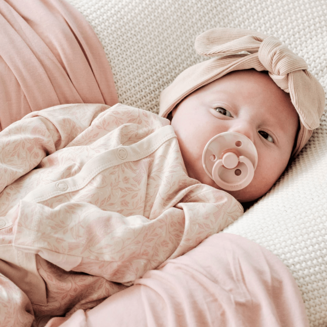 Close-up-of-Baby-Girl-Wearing-Aster-and-Oak-Organic-Cotton-Baby-Pyjamas-Song-Bird-Naked-Baby-Eco-Boutique
