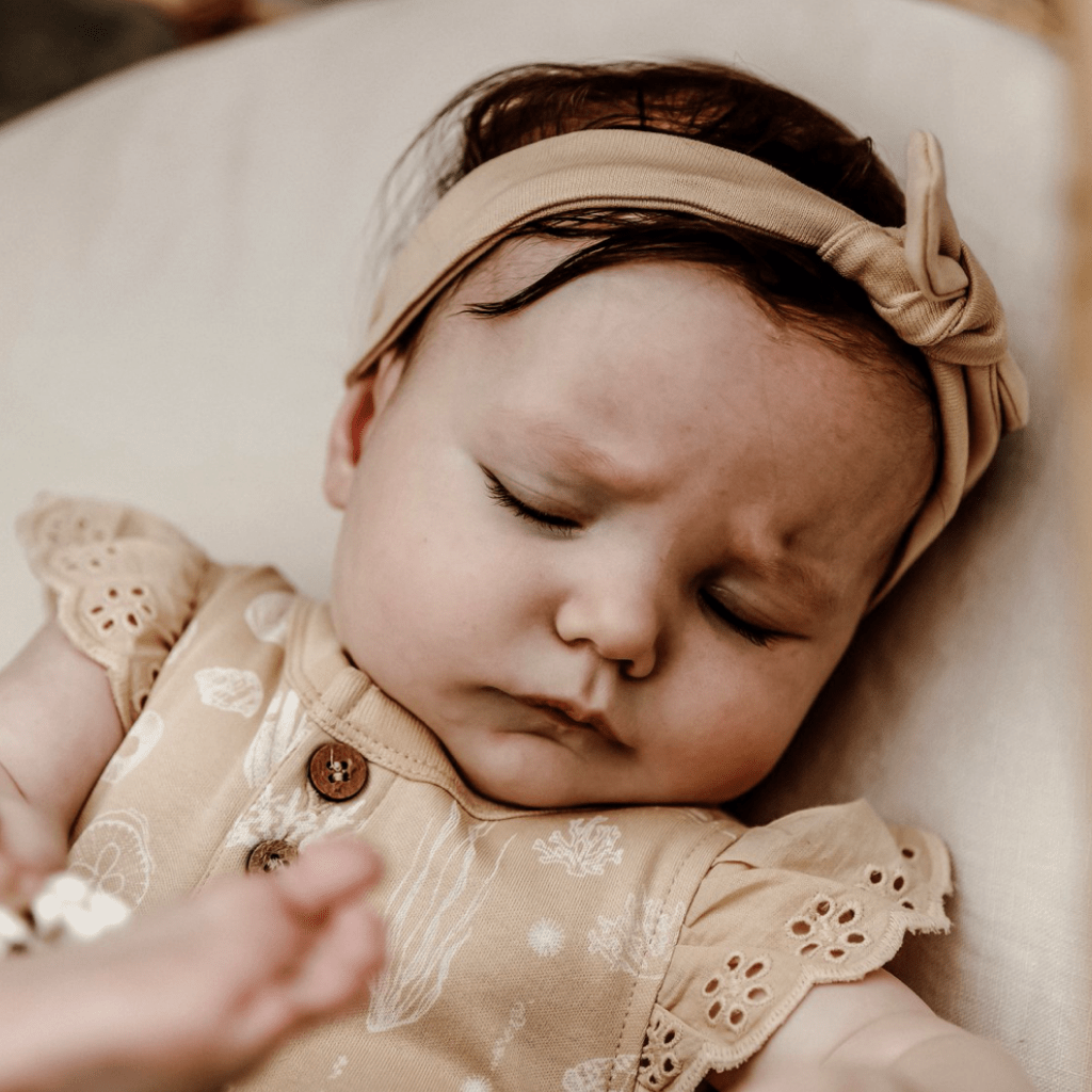 Close-up-of-Baby-Wearing-Aster-and-Oak-Organic-Mermaid-Lace-Henley-Onesie-Naked-Baby-Eco-Boutique