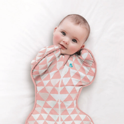 Close-up-of-Baby-in-Baby-in-Cot-Wearing-Love-to-Dream-Bamboo-Swaddle-Up-Lite-Coral-Naked-Baby-Eco-Boutique