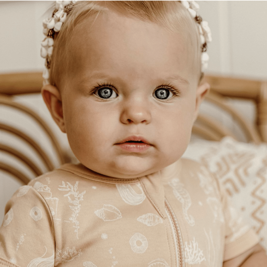 Close-up-of-Beautiful-Baby-Wearing-Aster-and-Oak-Organic-Mermaid-Zip-Romper-Naked-Baby-Eco-Boutique