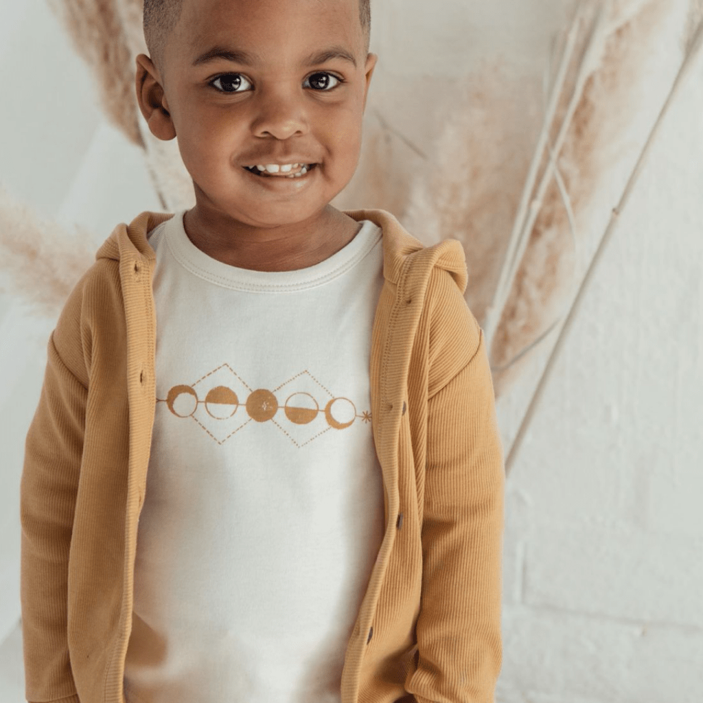 Close-up-of-Cute-Little-Boy-Wearing-Aster-and-Oak-Long-Sleeve-Tee-Moon-Phases-Naked-Baby-Eco-Boutique