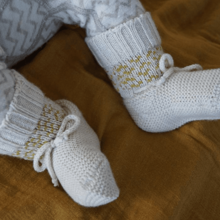 Close-up-of-Little-Feet-Wearing-Lola-and-Me-Merino-Knit-Booties-Arrow-Naked-Baby-Eco-Boutique