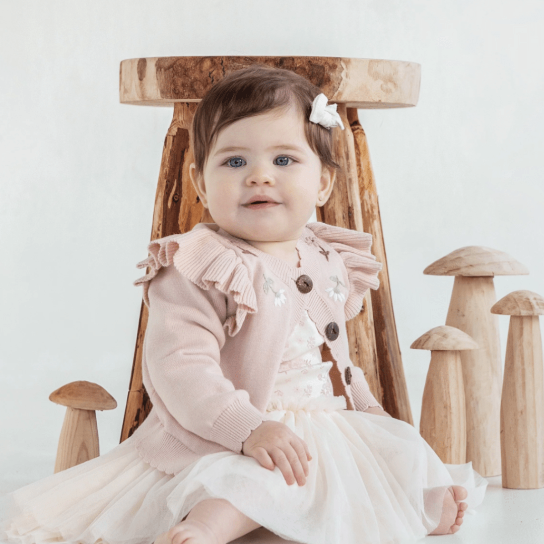 Cute-Baby-Girl-Sitting-Smiling-Wearing-Aster-and-Oak-Organic-Tutu-Dress-Emmy-Floral-Naked-Baby-Eco-Boutique