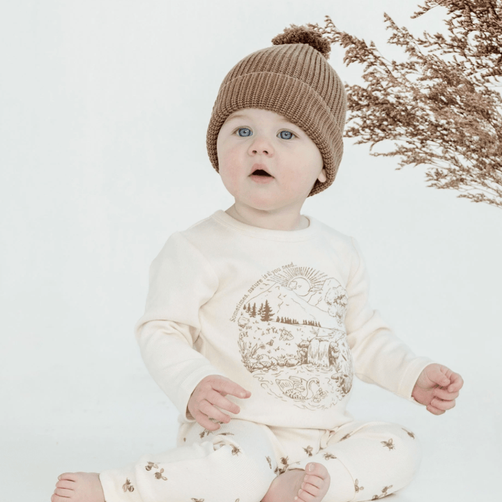 Cute-Baby-Sitting-Up-Wearing-Aster-and-Oak-Organic-Cotton-Pom-Pom-Beanie-Umber-Naked-Baby-Eco-Boutique
