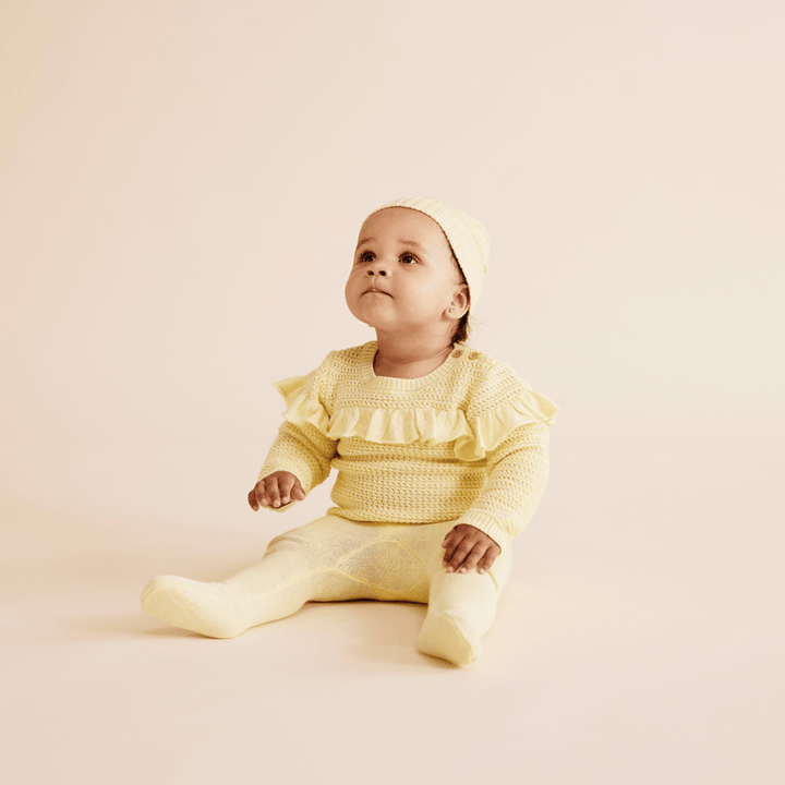 Cute-Baby-Sitting-Wearing-Wilson-and-Frenchy-Knitted-Legging-with-Feet-Pastel-Yellow-Naked-Baby-Eco-Boutique