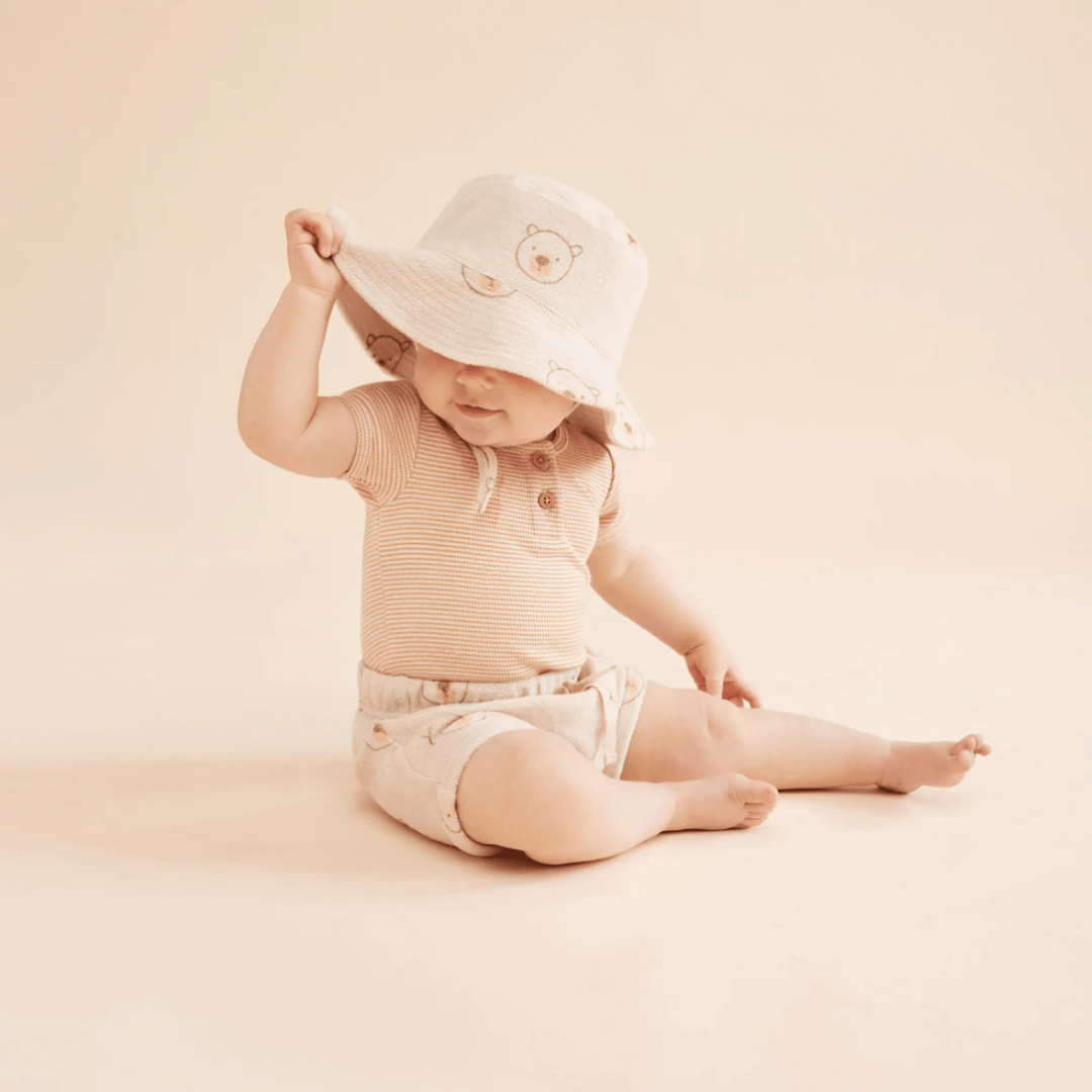 Cute-Baby-Wearing-Sunhat-and-Wilson-and-Frenchy-Organic-Rib-Stripe-Henley-Onesie-Toffee-Stripe-Naked-Baby-Eco-Boutique