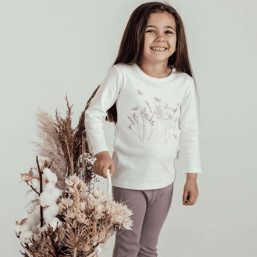 Cute-Little-Girl-Smiling-Wearing-Aster-and-Oak-Long-Sleeve-Tee-Wildflower-Naked-Baby-Eco-Boutique
