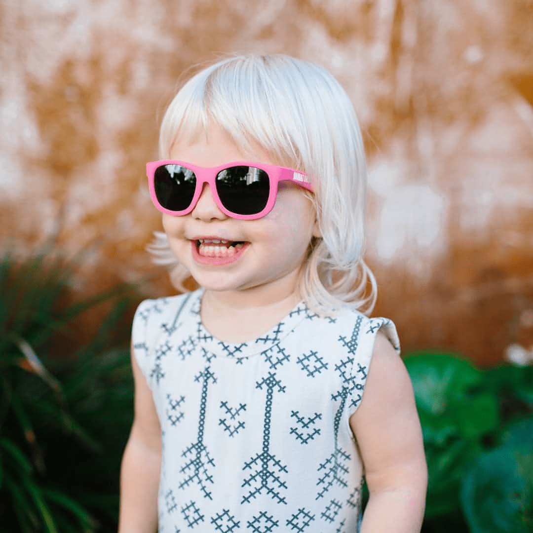 Cute-Little-Girl-Smiling-Wearing-Babiators-Navigators-Baby-Kids-Sunglasses-Think-Pink-Naked-Baby-Eco-Boutique