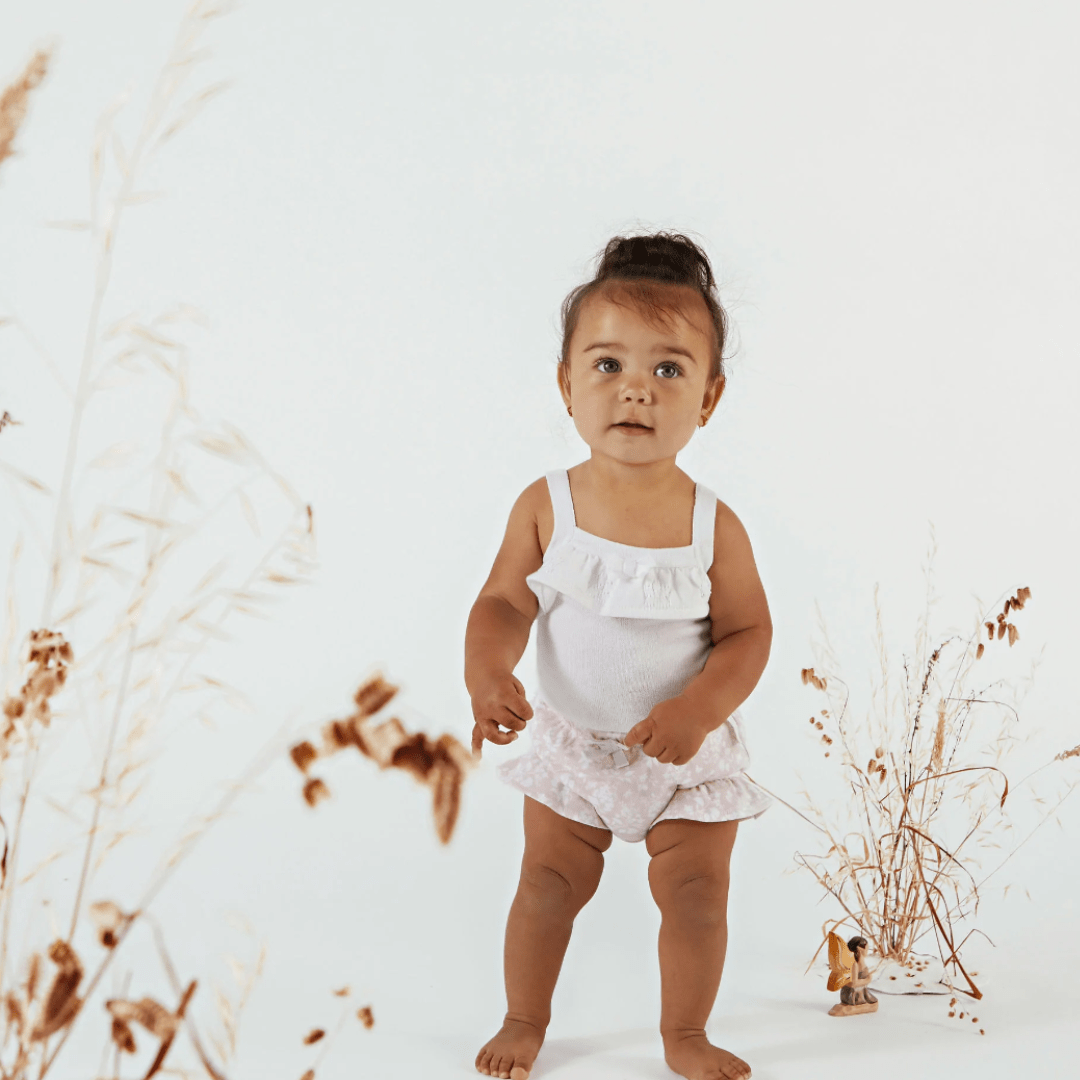 Cute-Little-Girl-Standing-Wearing-Aster-and-Oak-Organic-Ruffle-Bloomers-Naked-Baby-Eco-Boutique